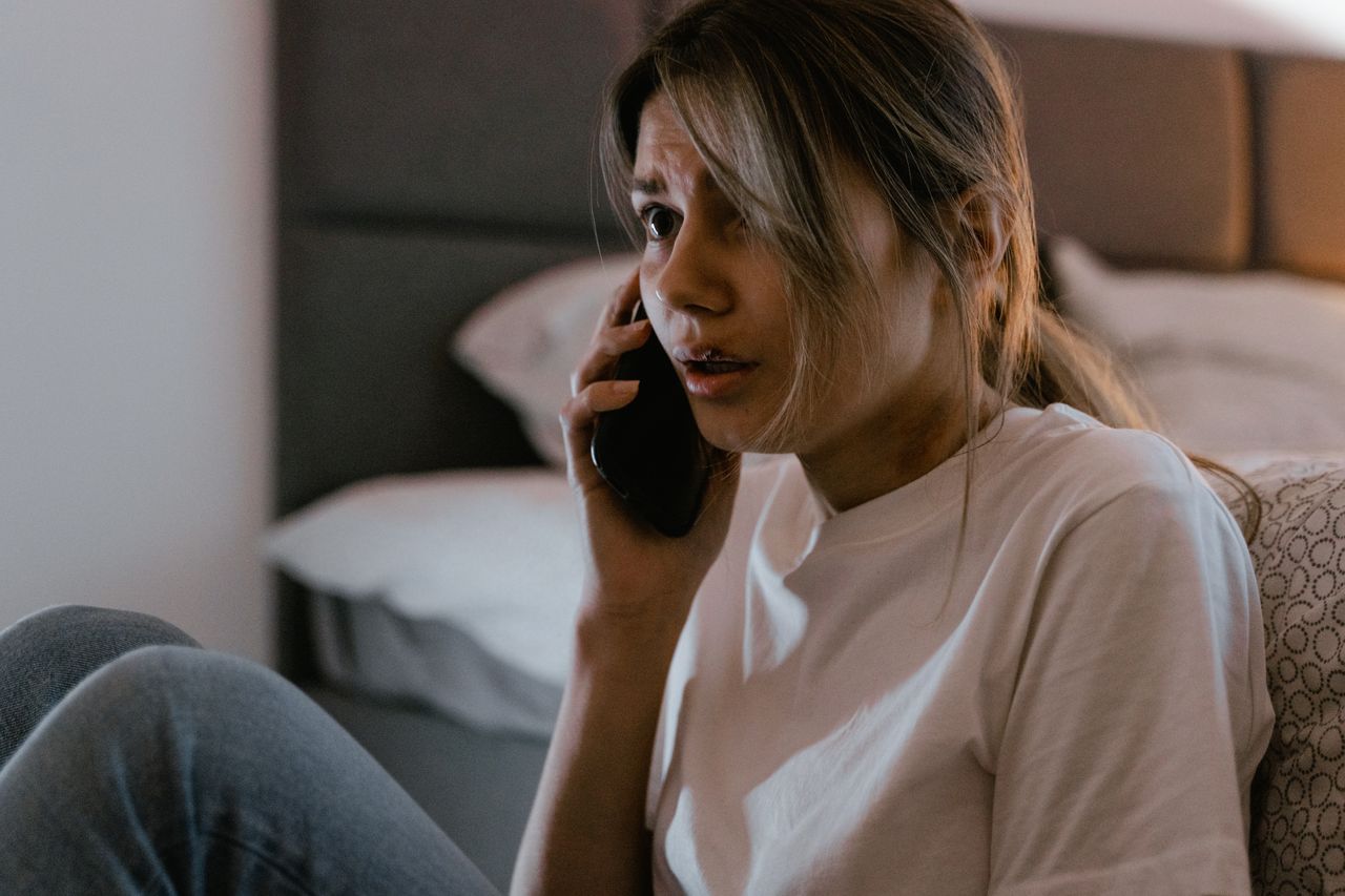 A person looking uneasy at a call from an unknown number